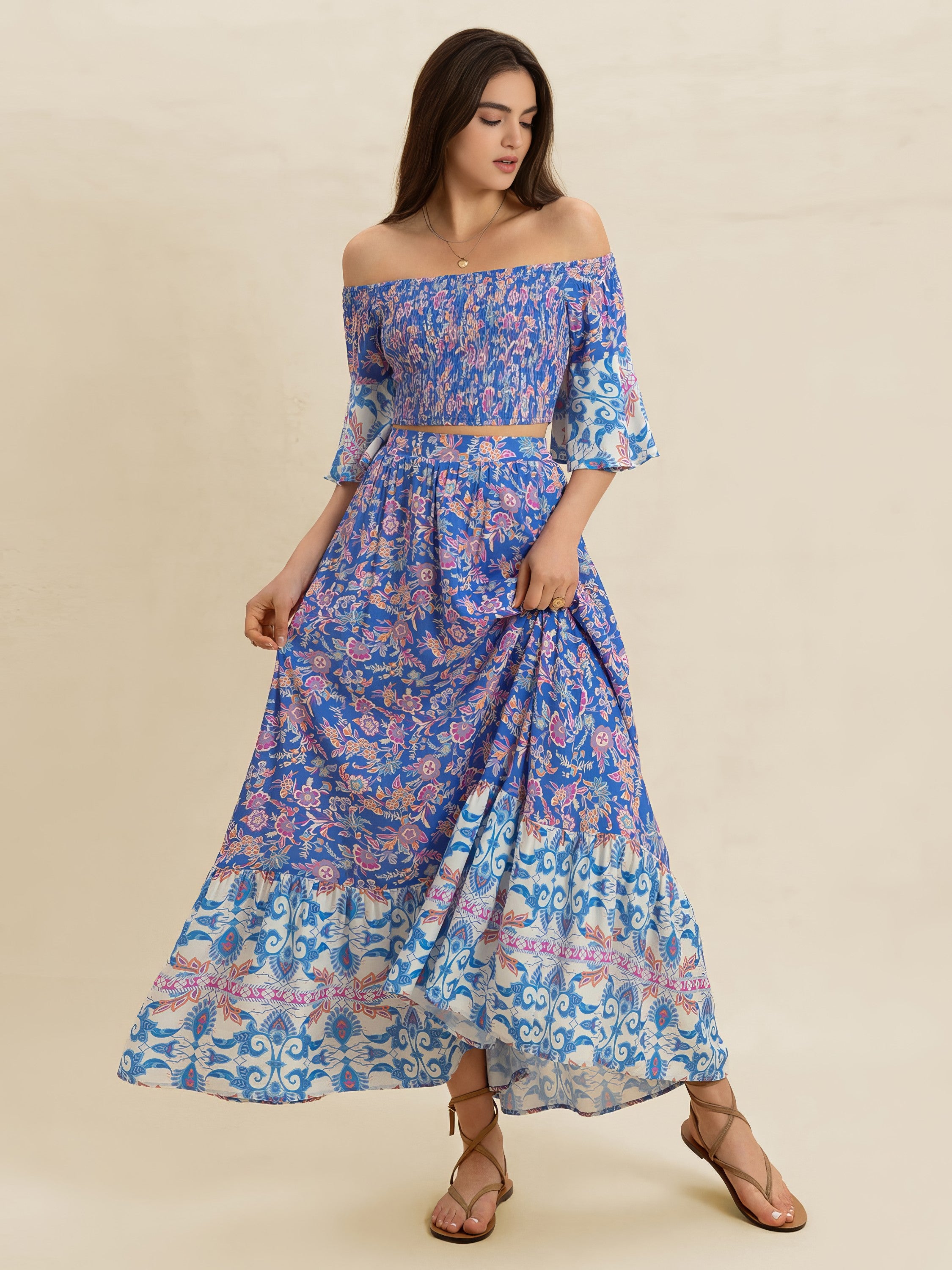 Woman wearing a blue floral off-shoulder dress on a beige background