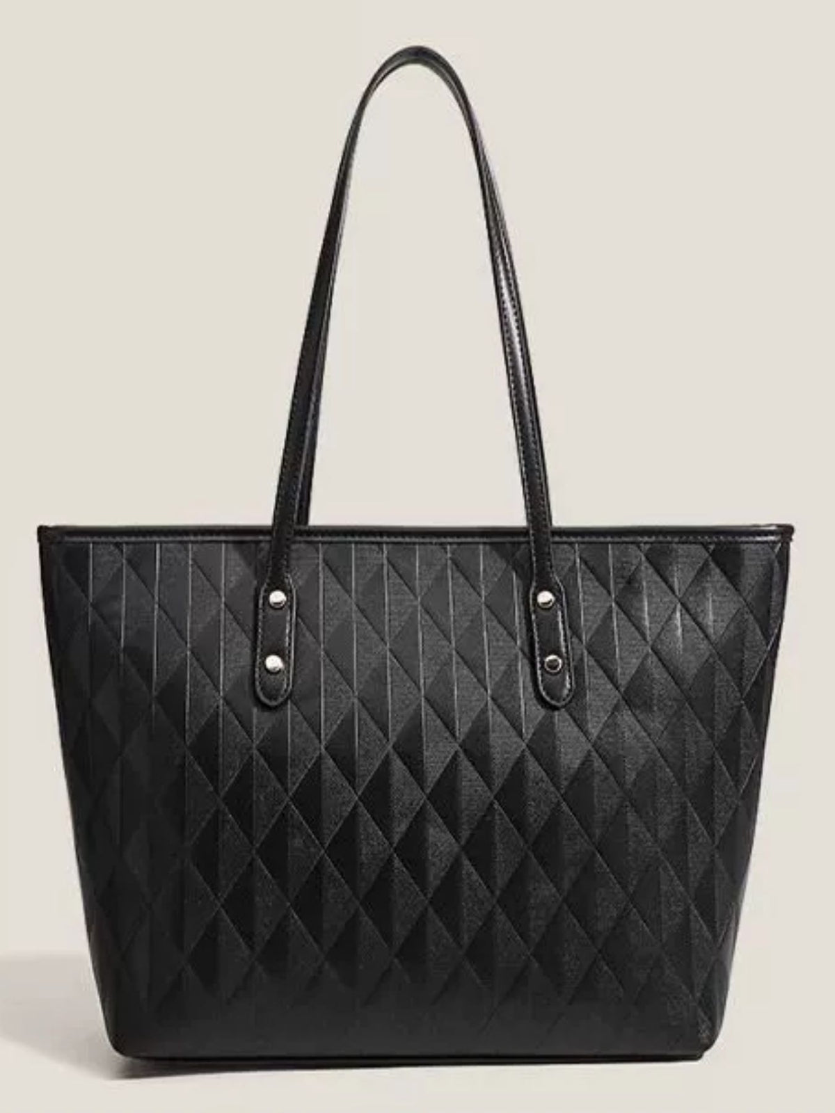 Large black textured PU leather tote bag with a structured trapezoid silhouette, diamond-quilted pattern, long shoulder straps, and silver-tone rivets.