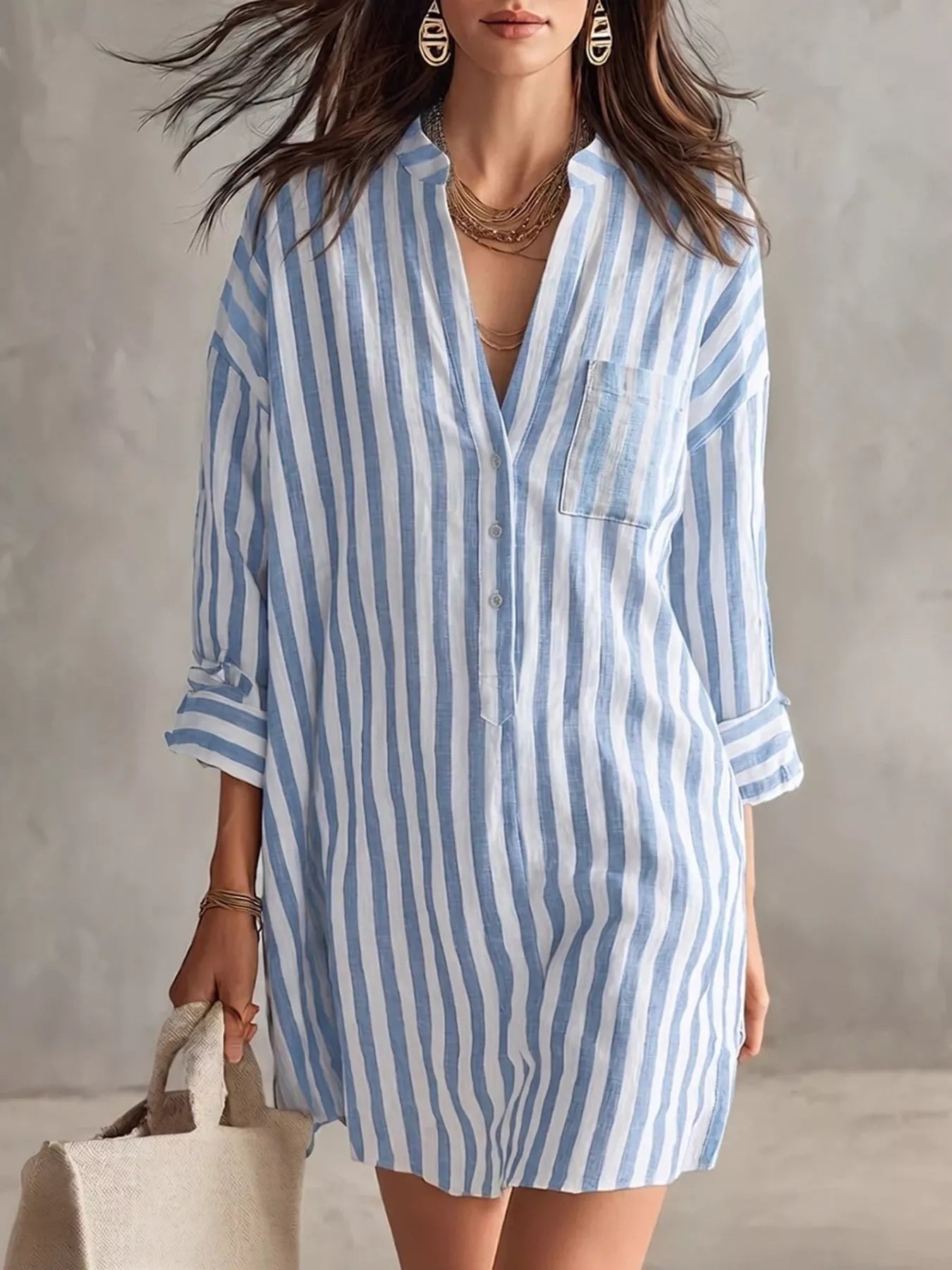 Plus-size blue and white striped shirt mini dress with button front, chest pocket, and rolled sleeves