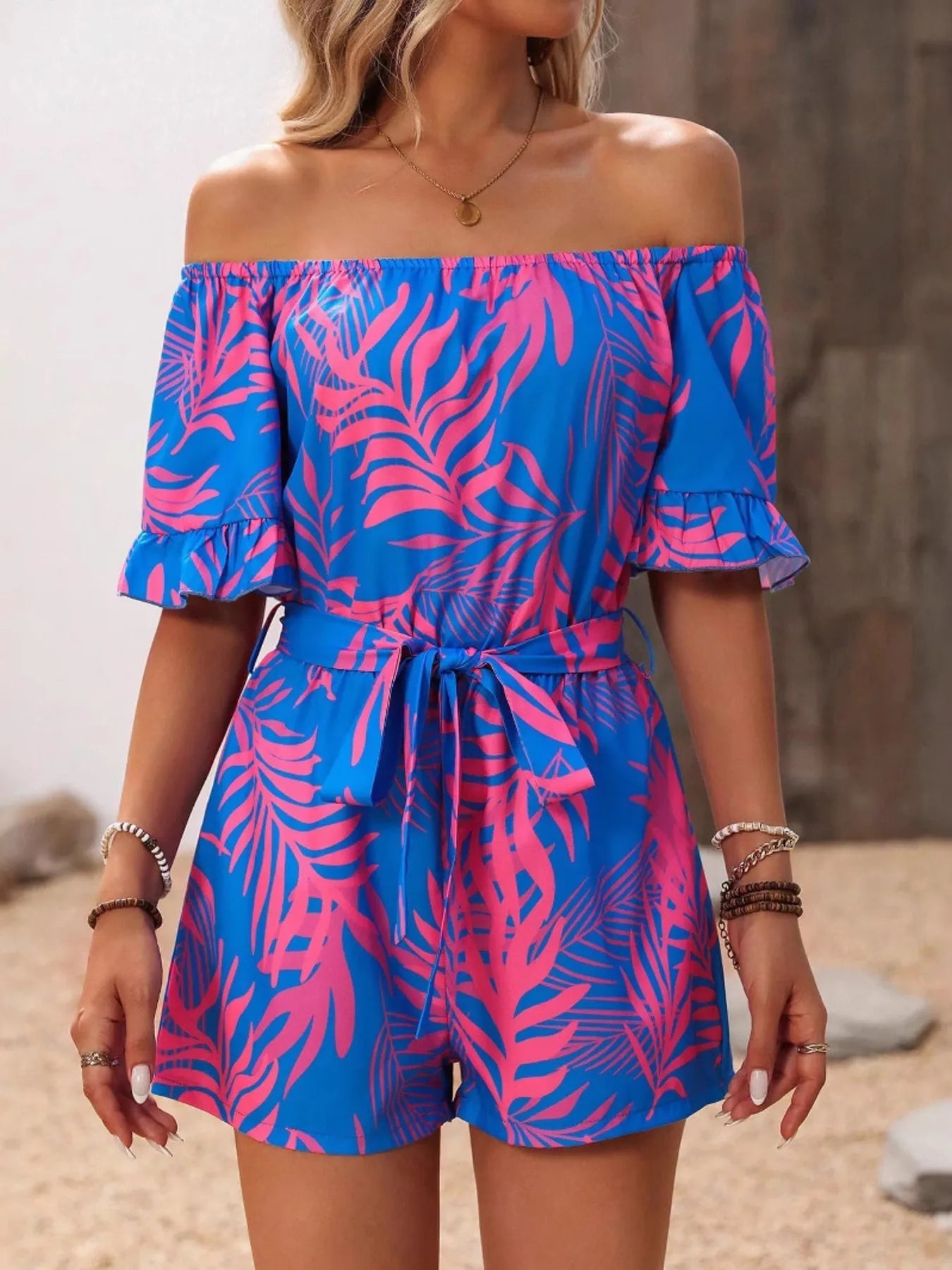Tropical Print Off-Shoulder Romper with Tie and Ruffles.