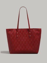 Large red PU leather tote bag with a textured diamond-quilted construction, structured rectangular silhouette, long shoulder straps, and riveted strap tabs.