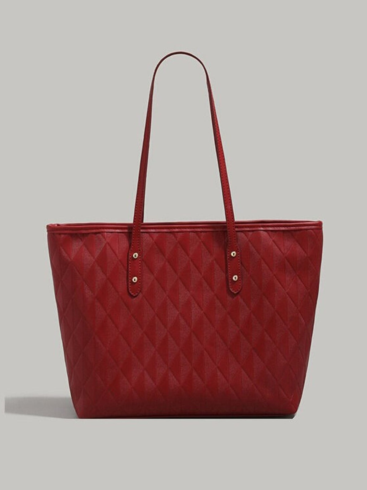 Large red PU leather tote bag with a textured diamond-quilted construction, structured rectangular silhouette, long shoulder straps, and riveted strap tabs.