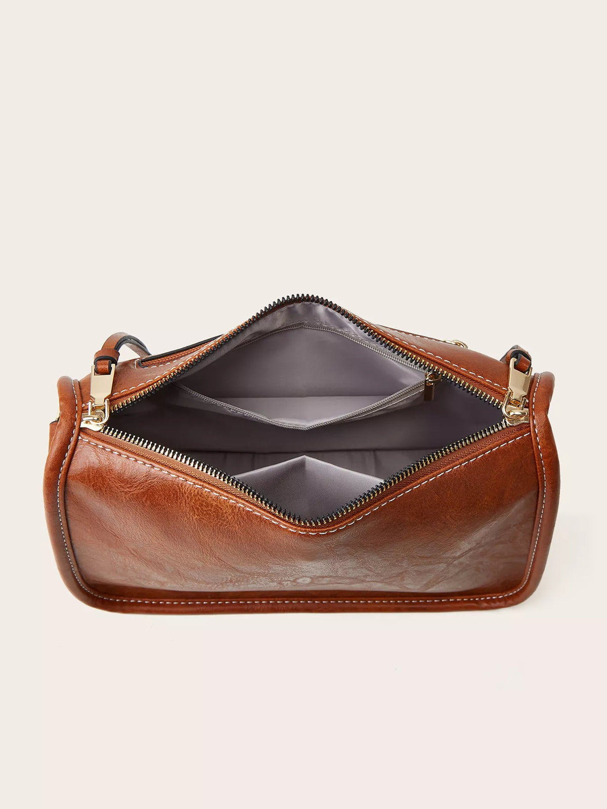 Small vintage-style brown PU leather crossbody bag shown open, featuring a structured silhouette, stitched edges, gold-tone hardware, and a zippered interior with compartments.