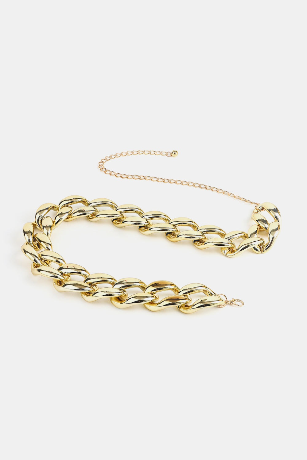 Glossy gold-tone acrylic curb chain belt featuring bold interlocking links and a slender draped chain extension for adjustable waist or hip styling.