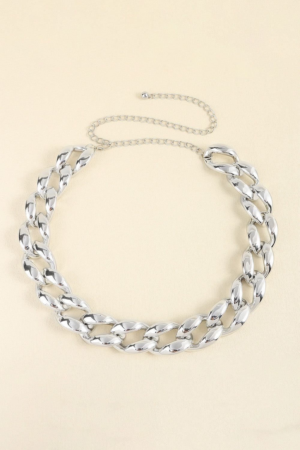 Silver-tone acrylic curb chain belt featuring chunky interlocking links, a 1.2-inch width, and a slender draped chain extension with adjustable fastening.
