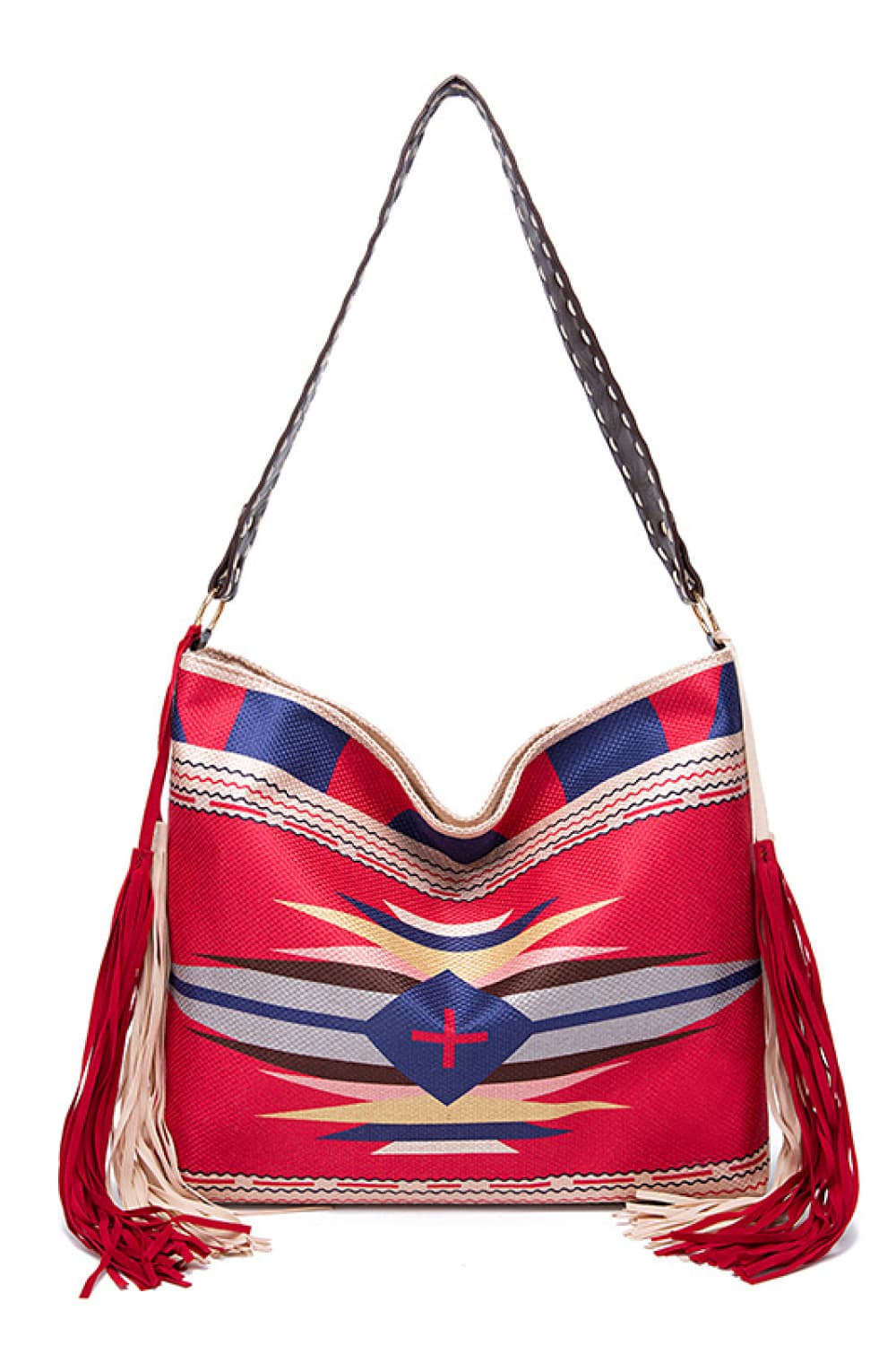 Oversize geometric canvas tote bag in red with navy, cream, and black woven patterns, a curved top, long shoulder strap, and fringe trim.