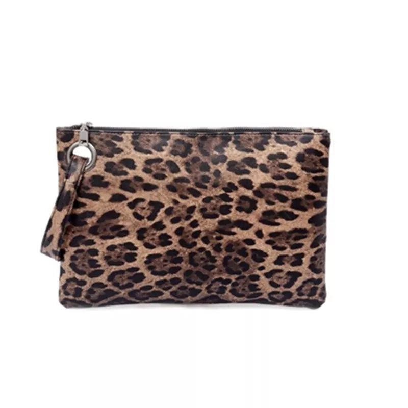 Small PU leather leopard print clutch bag with a rectangular silhouette, top zipper closure, and attached wrist strap.