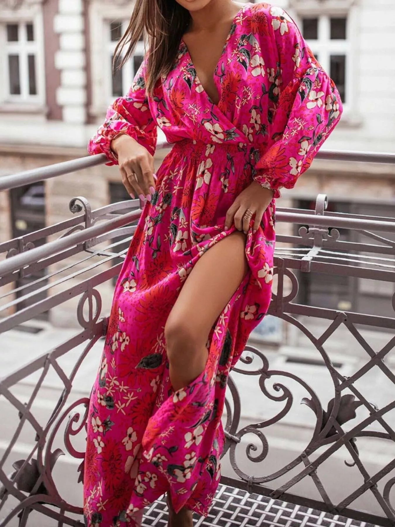 Bohemian floral printed maxi dress with plunging neckline, ruched waist, tiered skirt, and long flowy sleeves