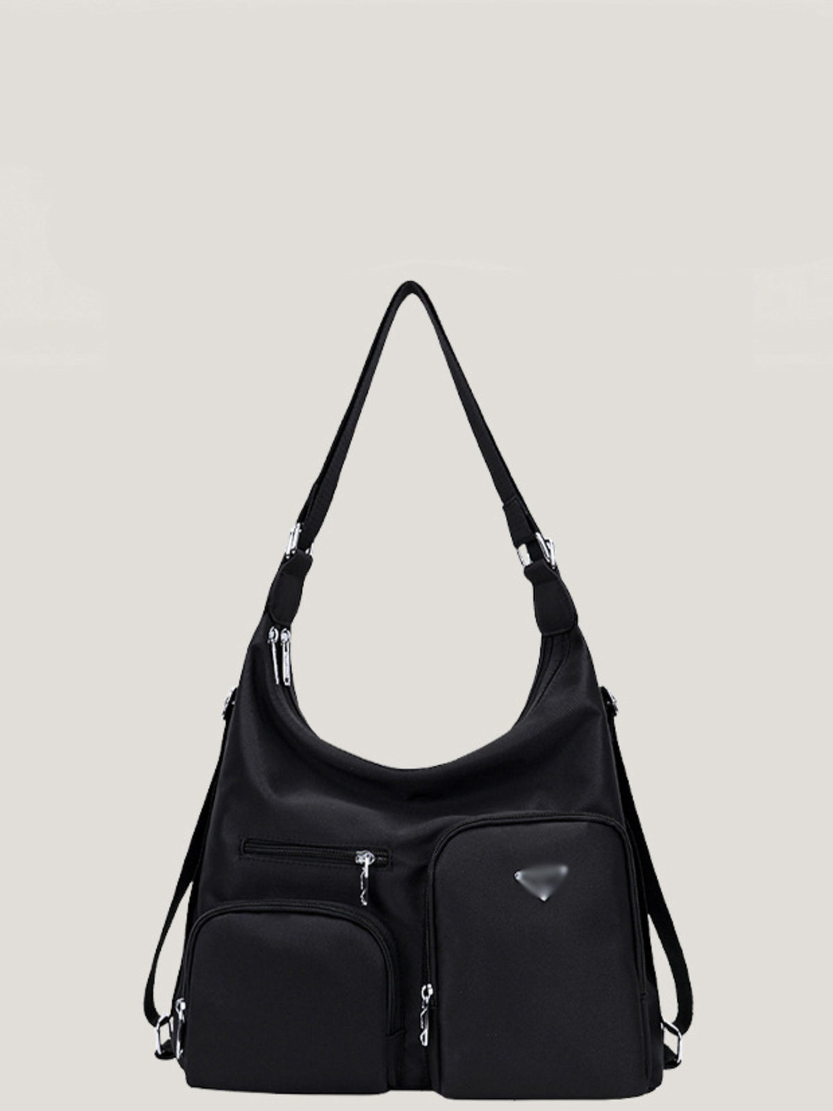 Black lightweight nylon shoulder bag with an adjustable strap, slouchy silhouette, silver hardware, and multiple front zip pockets for organized storage.