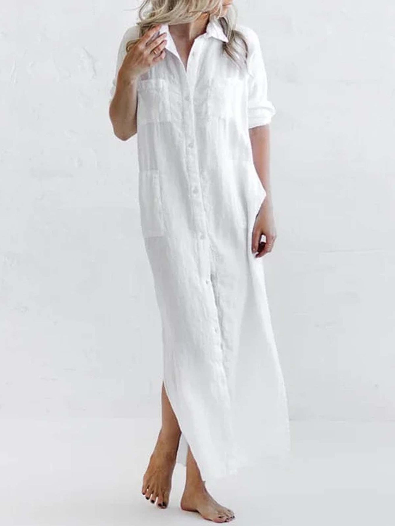 Plus-size green maxi shirt dress with collared neckline, button front, rolled sleeves, pockets, and side slit