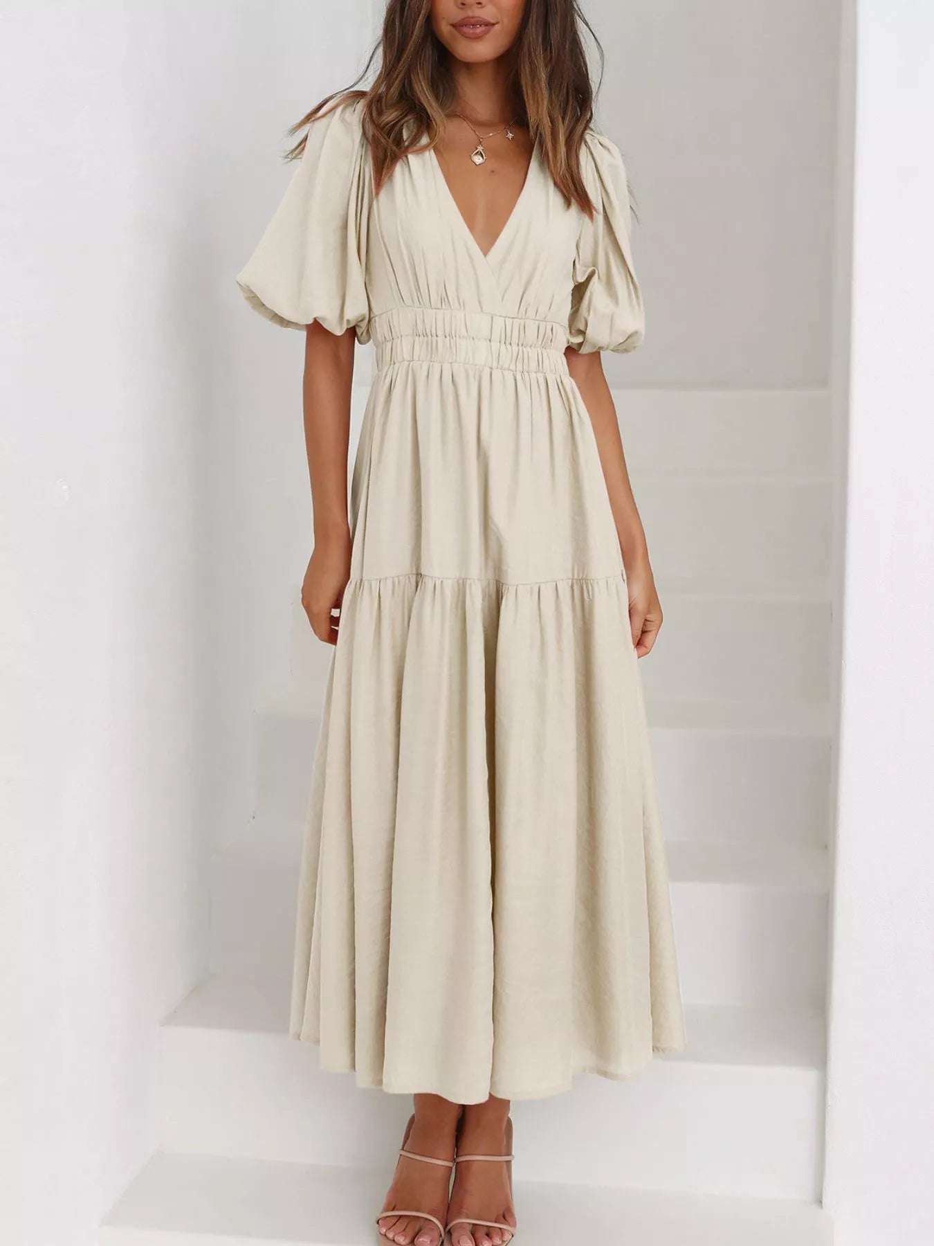 Cream tiered midi dress with a V-neck, smocked waist, and short puff sleeves