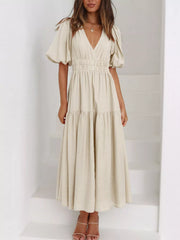 Cream tiered midi dress with a V-neck, smocked waist, and short puff sleeves