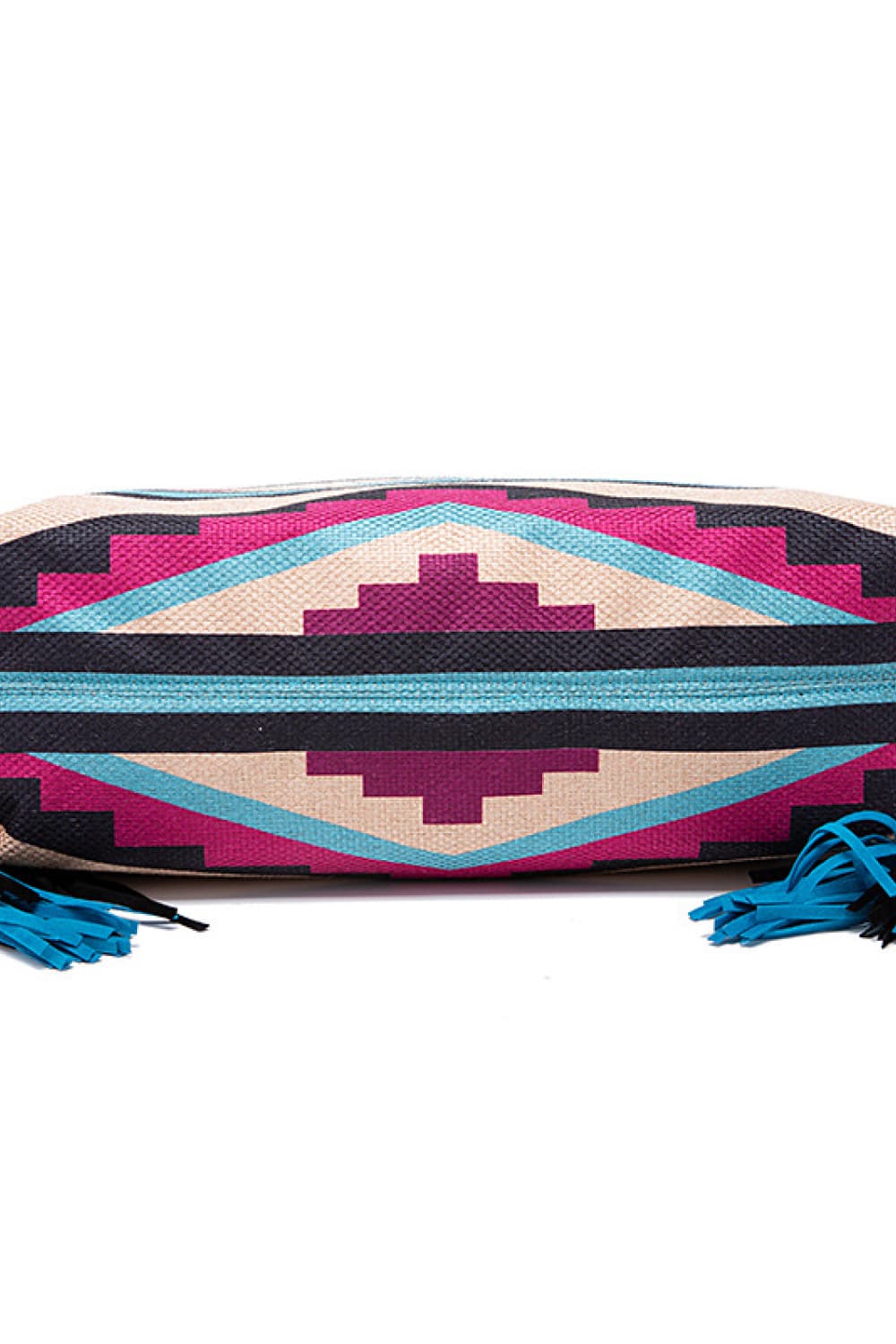 Geometric canvas tote bag featuring an oversized silhouette, bold turquoise, pink, beige, and black pattern, reinforced bands, and blue fringe tassel accents.
