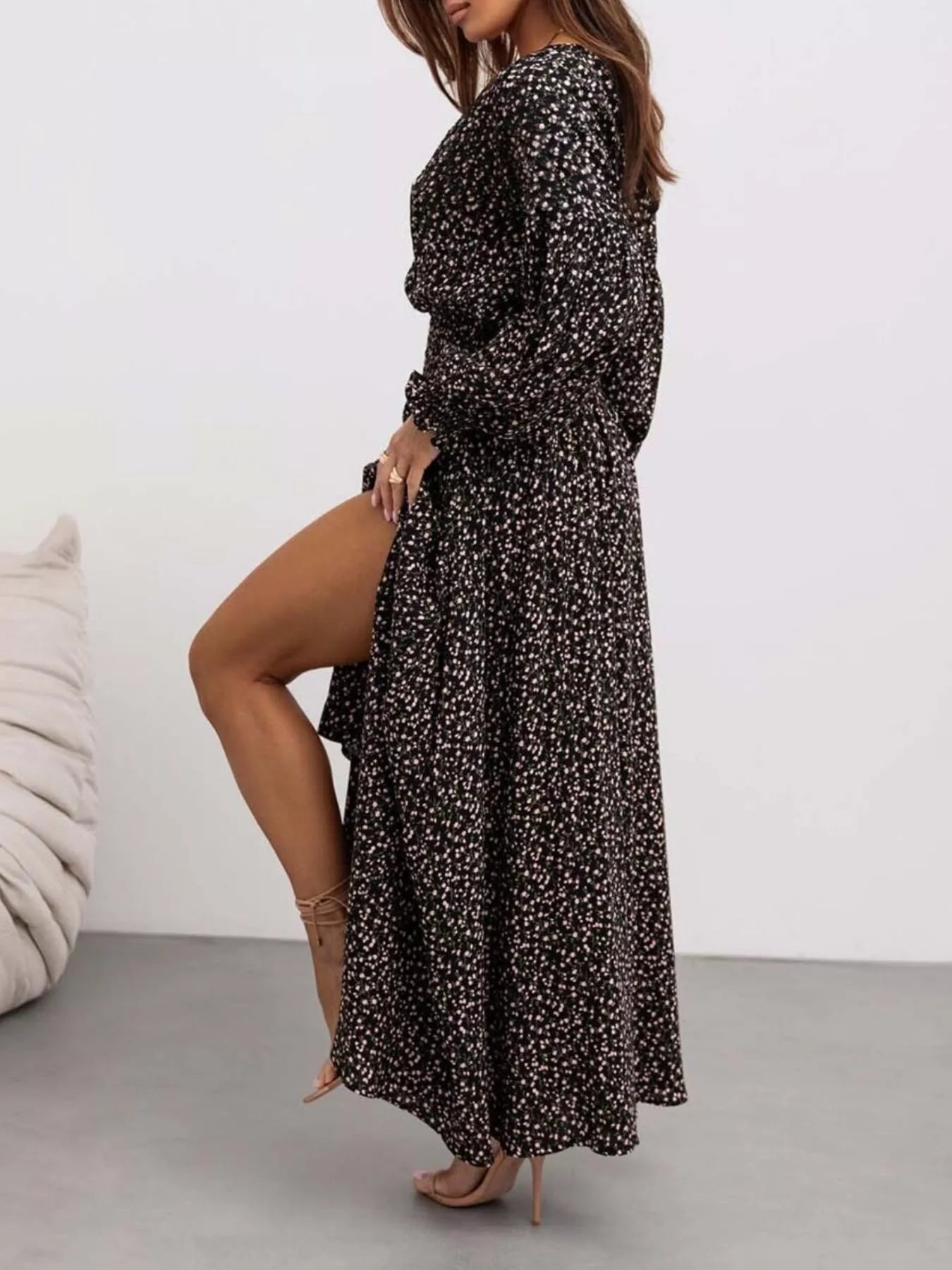Bohemian floral printed maxi dress with plunging neckline, ruched waist, tiered skirt, and long flowy sleeves