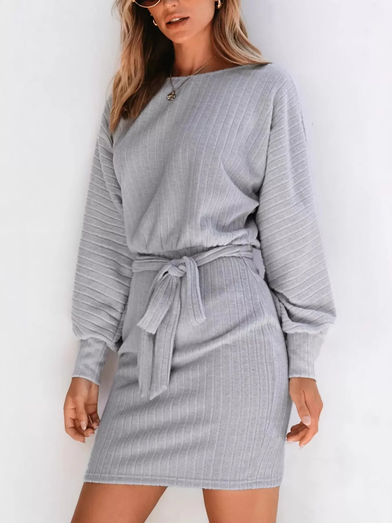 Gray ribbed mini dress with long sleeves, round neckline, and tie waist