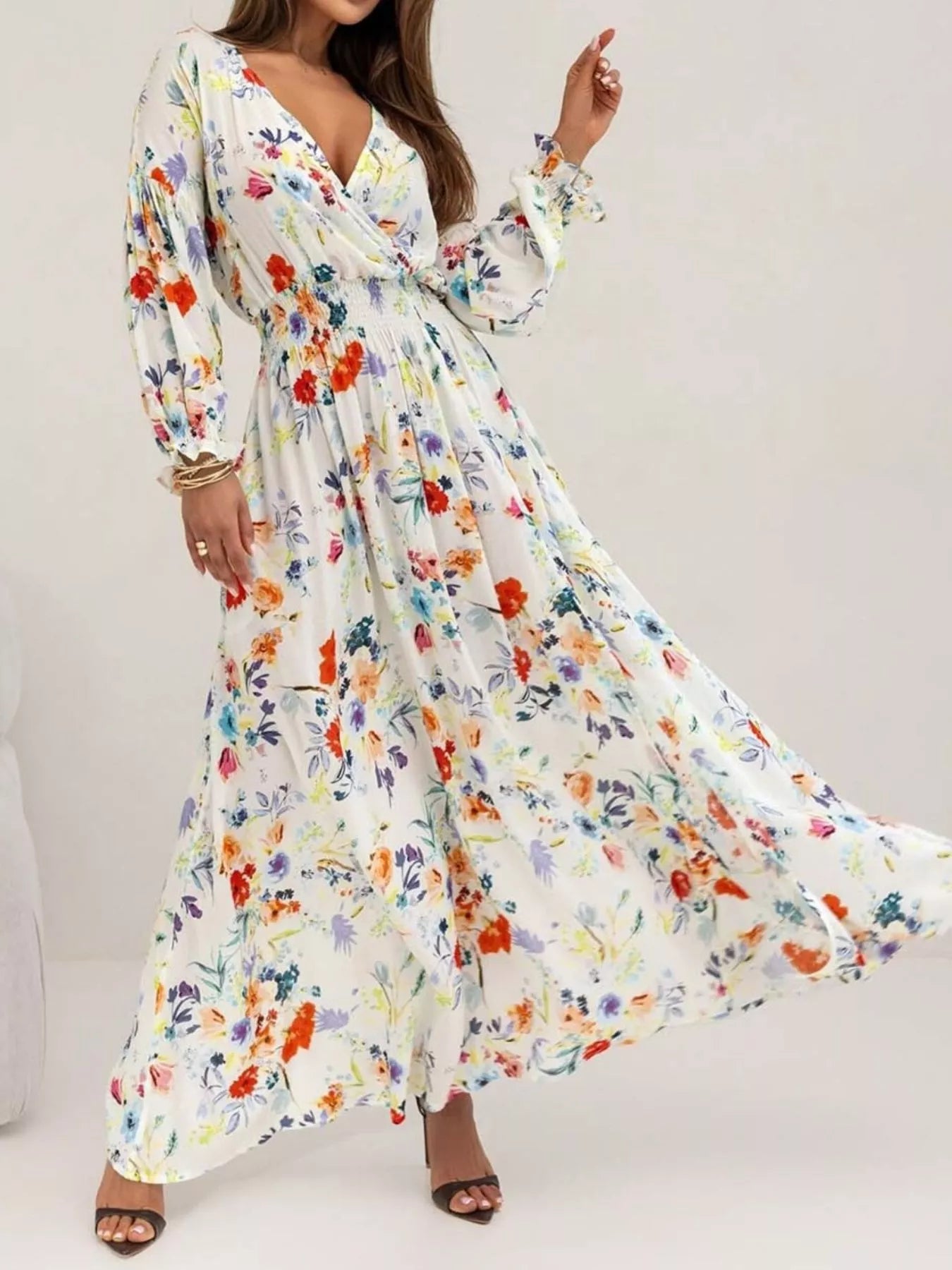 Bohemian floral printed maxi dress with plunging neckline, ruched waist, tiered skirt, and long flowy sleeves