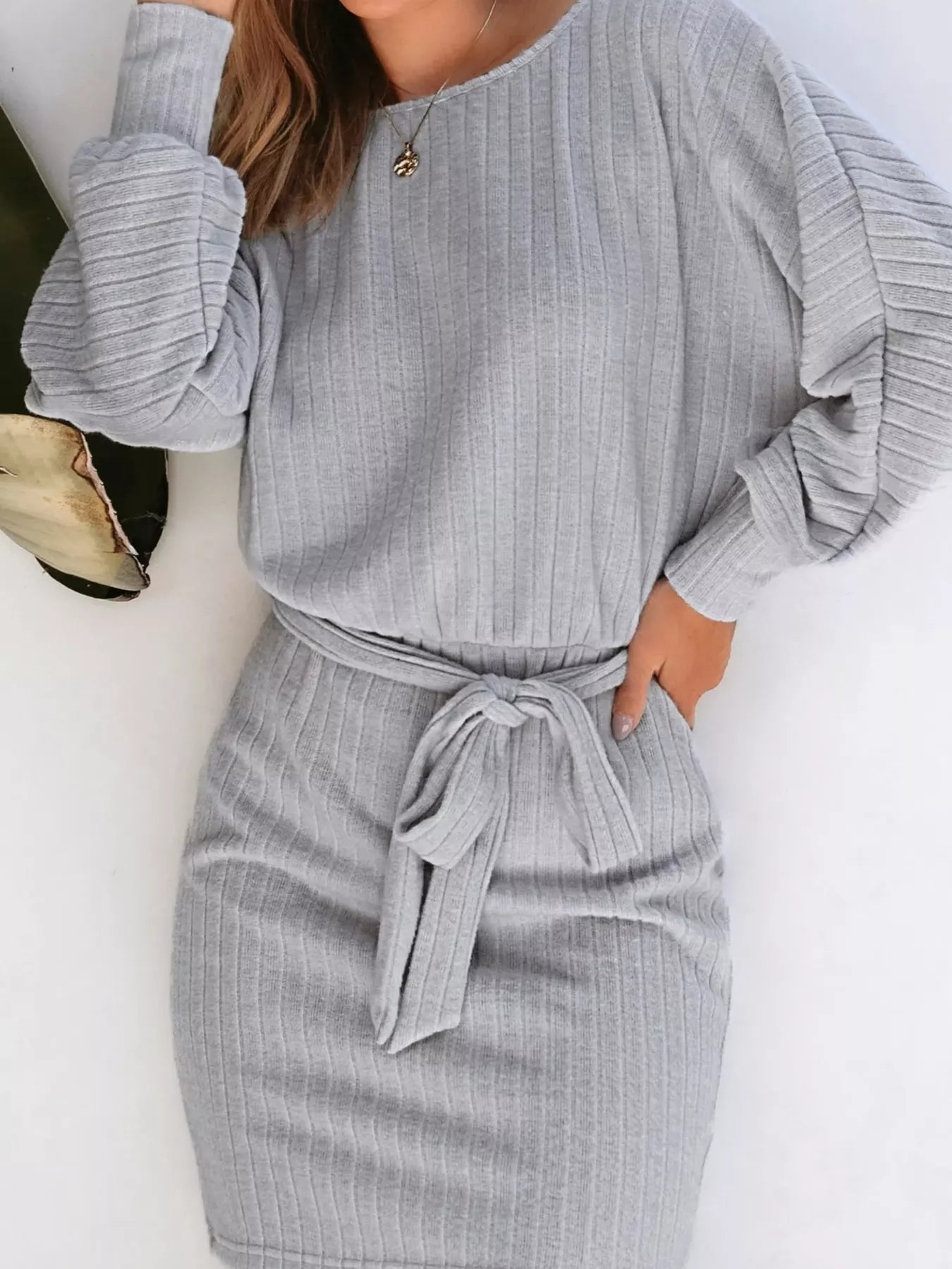 Gray ribbed mini dress with long sleeves, round neckline, and tie waist