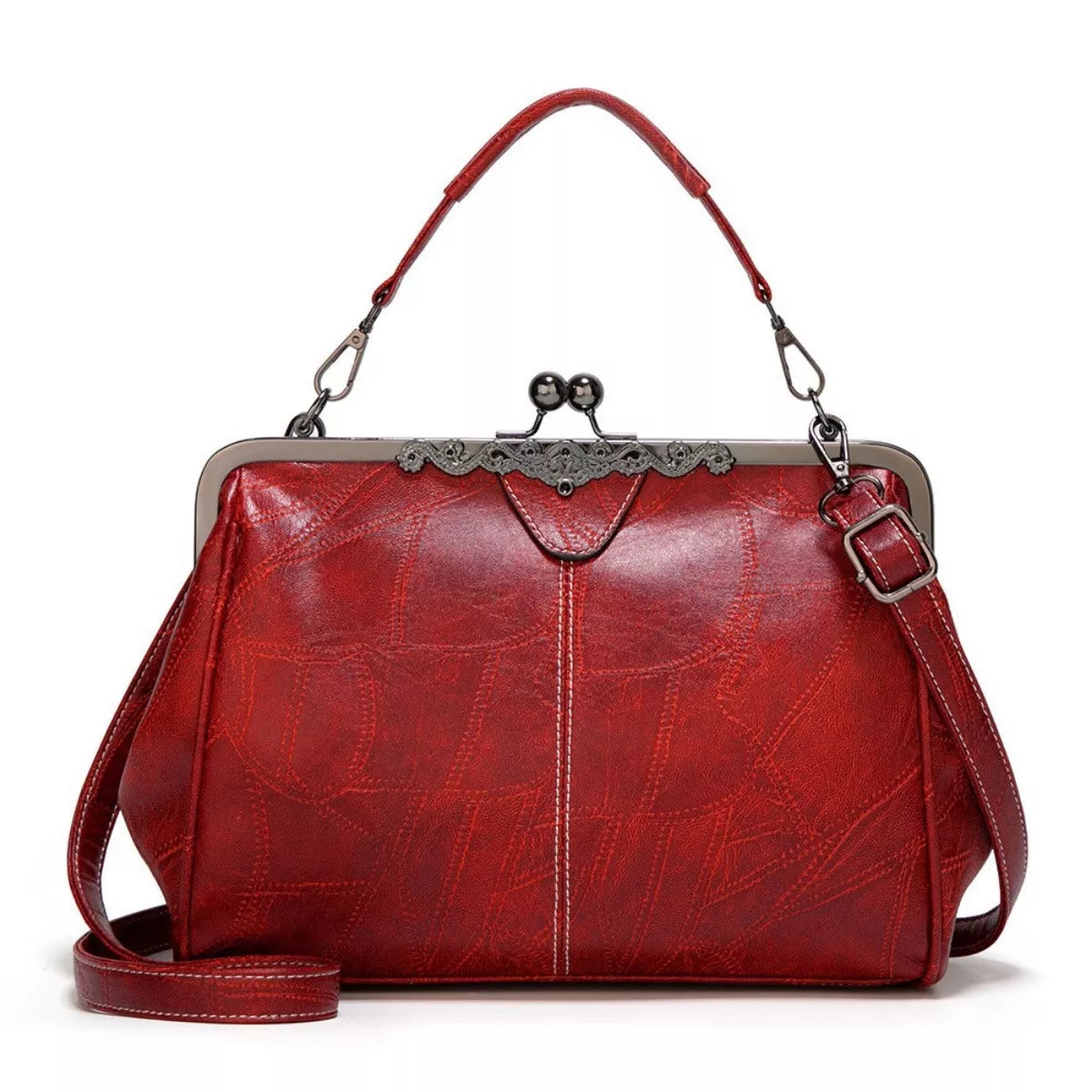 Medium red PU leather handbag with a structured silhouette, decorative kiss-lock clasp, short top handle, stitched detailing, and a detachable shoulder strap.