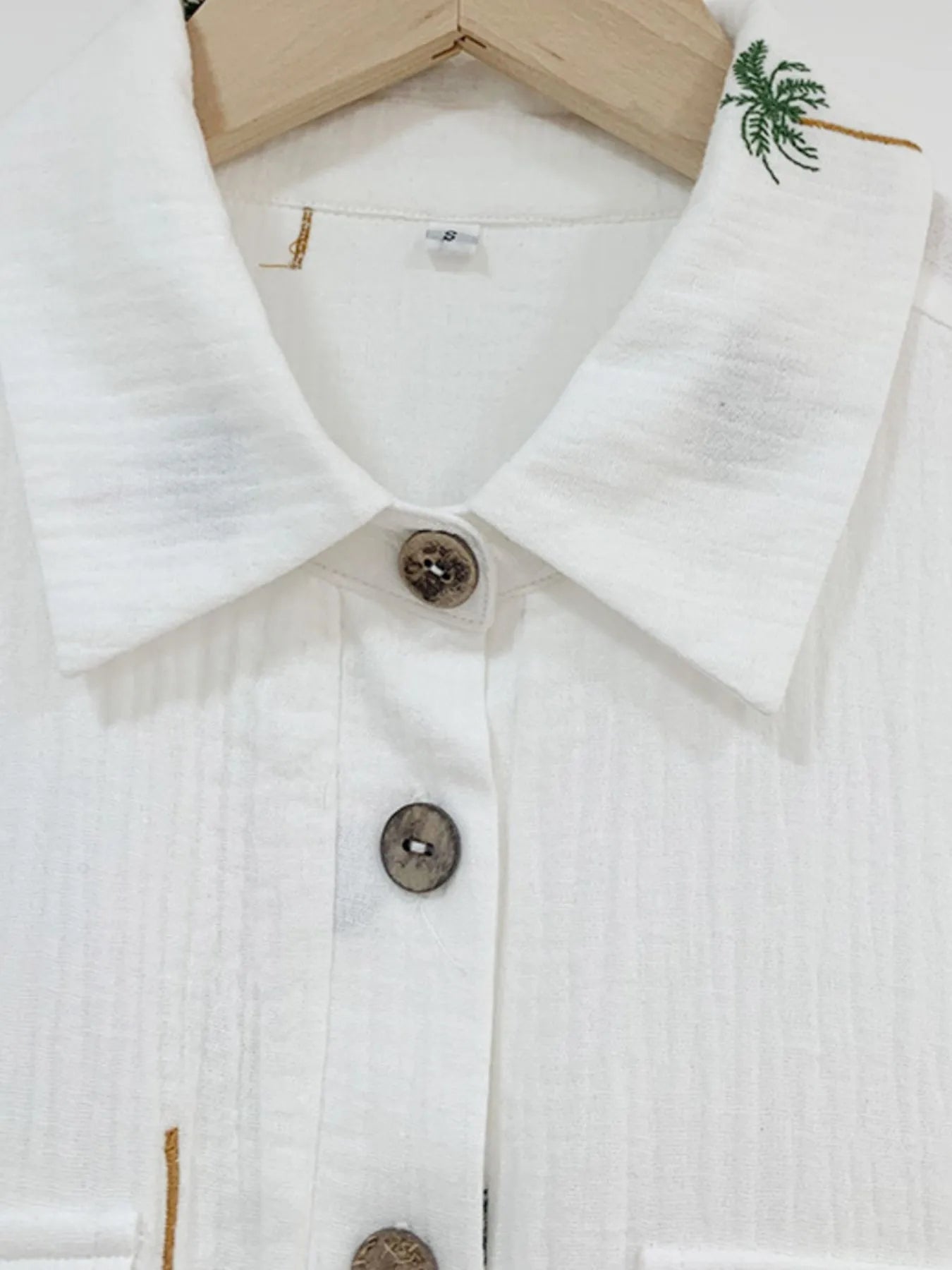 Palm Tree Print Short Sleeve Button-Up Romper with Belt and Pockets.