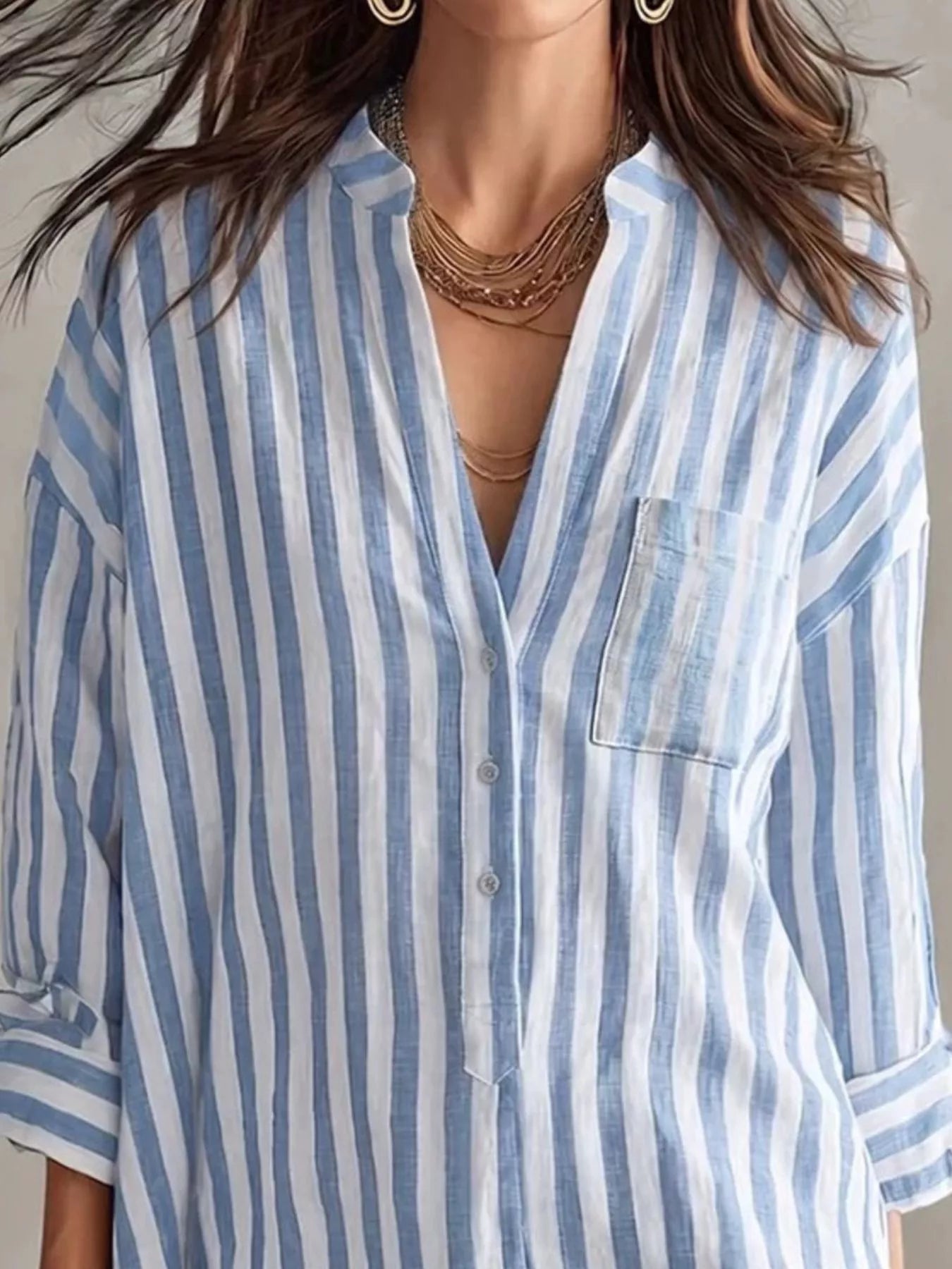 Plus-size blue and white striped shirt mini dress with button front, chest pocket, and rolled sleeves