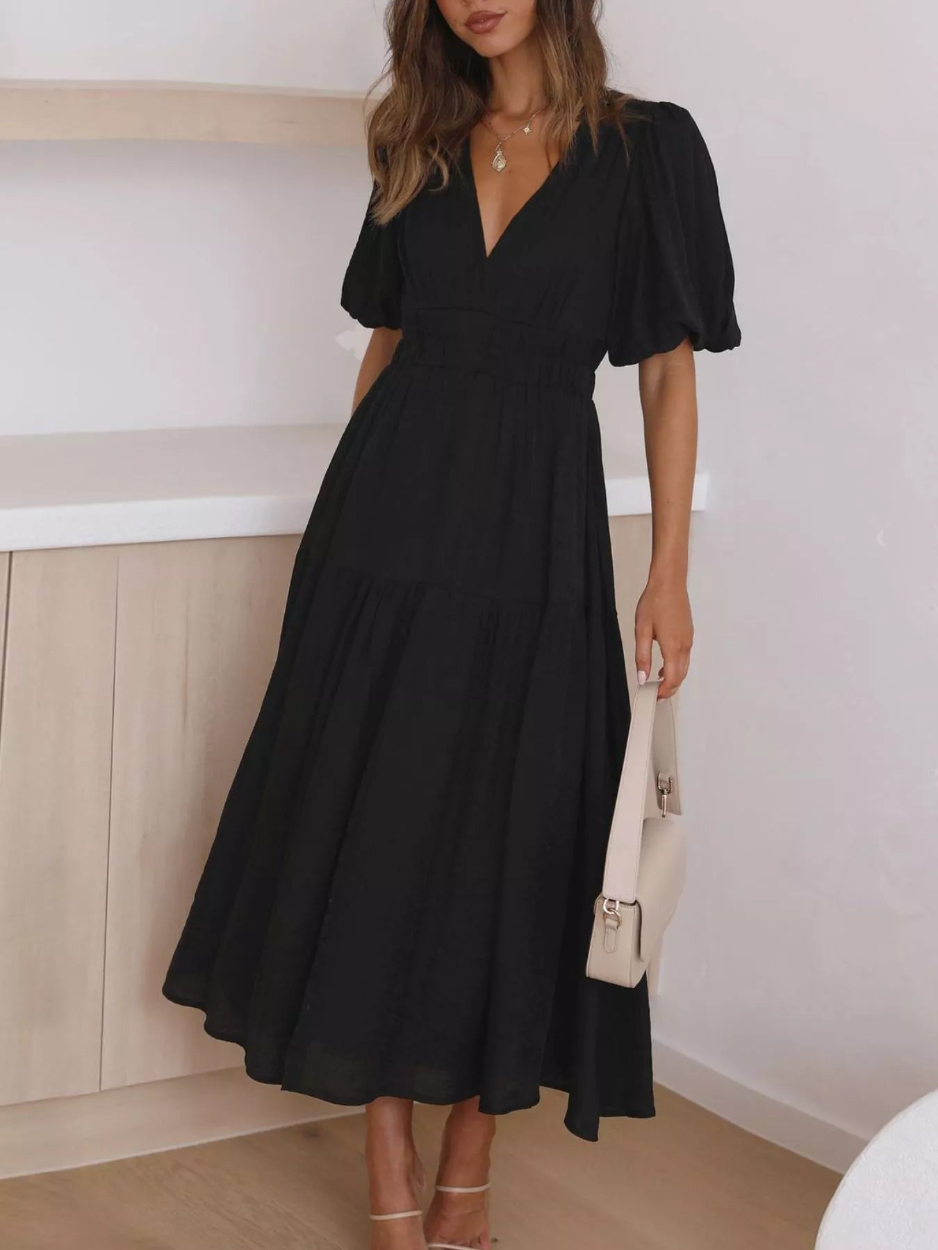 Cream tiered midi dress with a V-neck, smocked waist, and short puff sleeves