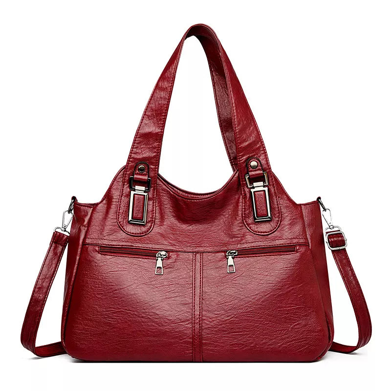 Large vintage-style burgundy PU leather handbag with dual top handles, adjustable shoulder strap, front zip pockets, and silver-tone hardware.
