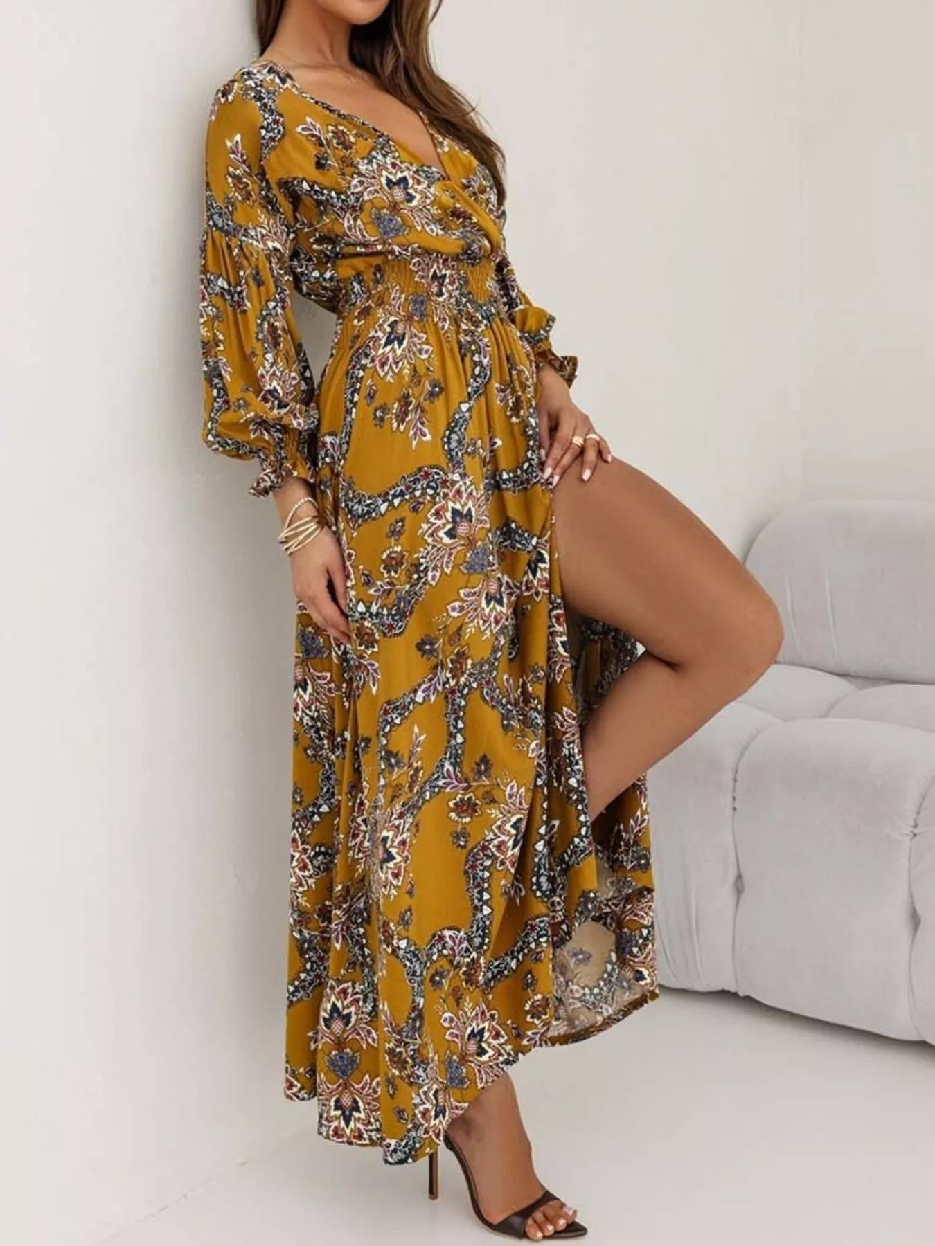 Bohemian floral printed maxi dress with plunging neckline, ruched waist, tiered skirt, and long flowy sleeves