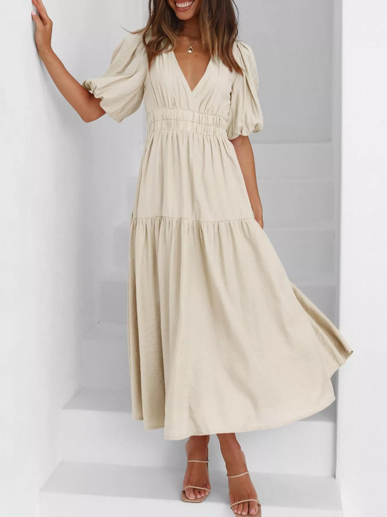 Cream tiered midi dress with a V-neck, smocked waist, and short puff sleeves