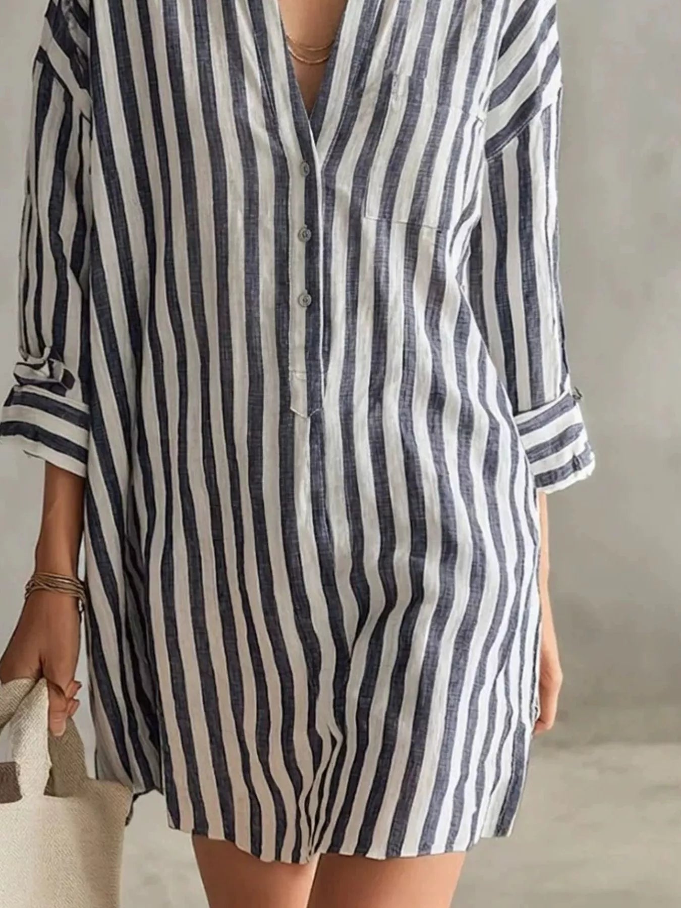 Plus-size blue and white striped shirt mini dress with button front, chest pocket, and rolled sleeves