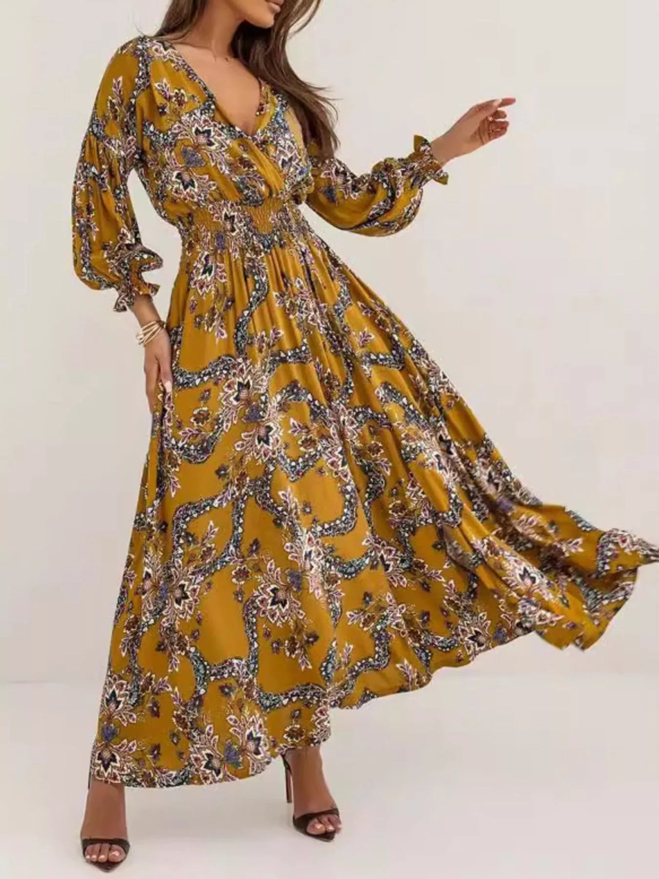 Bohemian floral printed maxi dress with plunging neckline, ruched waist, tiered skirt, and long flowy sleeves