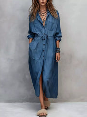 Plus size blue button-front shirt dress with long sleeves, drawstring waist, pockets, and side slit