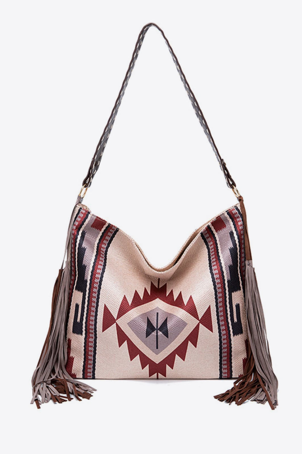 Oversize geometric canvas tote bag in beige with burgundy, navy, and black woven patterns, a curved top, long shoulder strap, and side fringe.