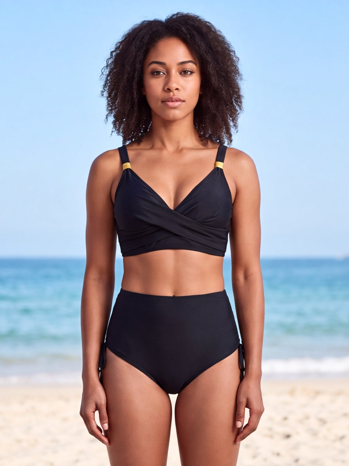 A front-facing model wears a black crisscross bikini with a wrap-style top, shoulder straps, and high-waisted bottoms with side ties.