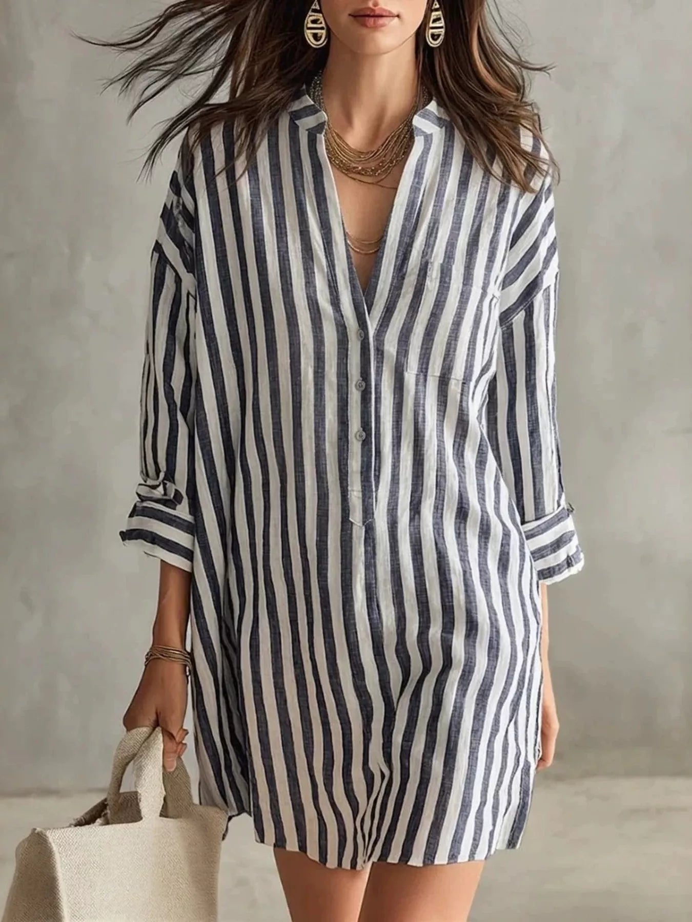Plus-size blue and white striped shirt mini dress with button front, chest pocket, and rolled sleeves