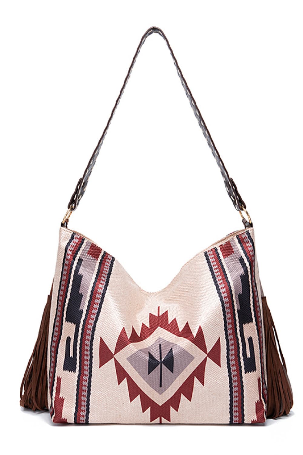 Oversize geometric canvas tote bag with a Southwestern-inspired red, navy, and beige pattern, long shoulder strap, and side fringe detailing.