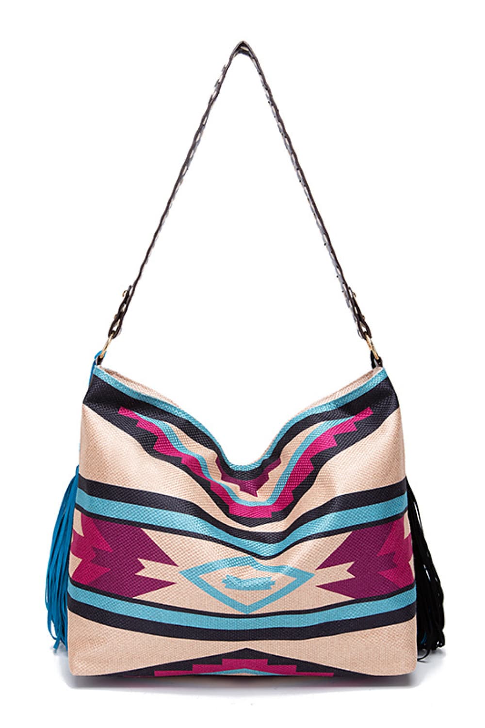 Oversized geometric canvas tote bag in beige, black, turquoise, and magenta, featuring a structured rectangular silhouette and long shoulder strap.