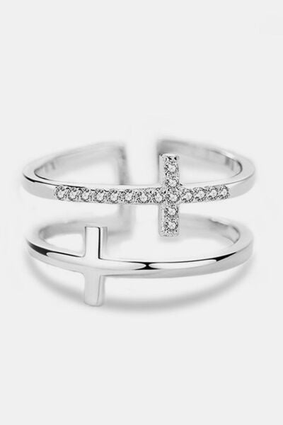 A polished 925 sterling silver adjustable cross ring features a slim open silhouette with zircon accents along the band and cross motif.