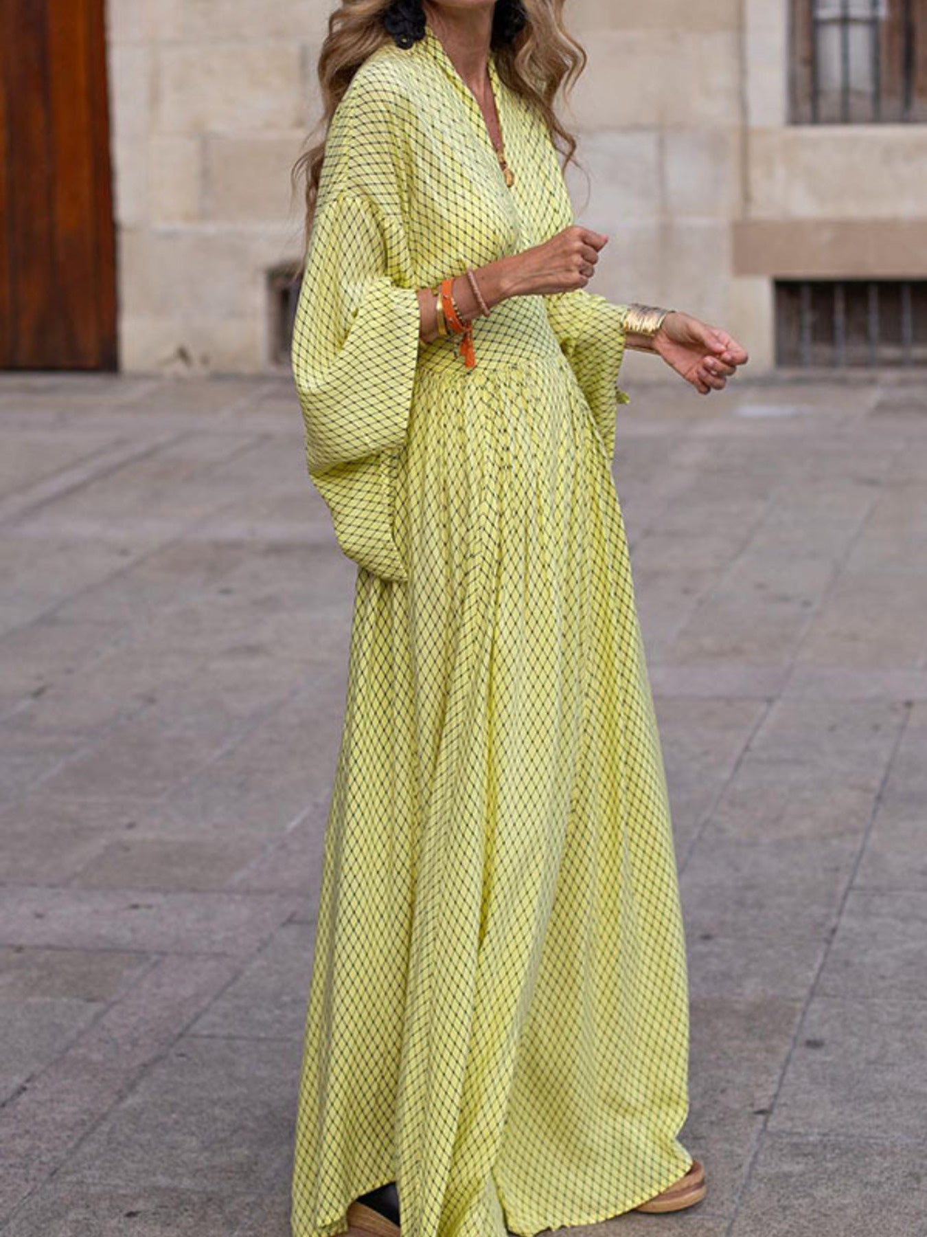 Flowy geometric maxi dress with V-neck and long sleeves in green, black, gray, red, and yellow