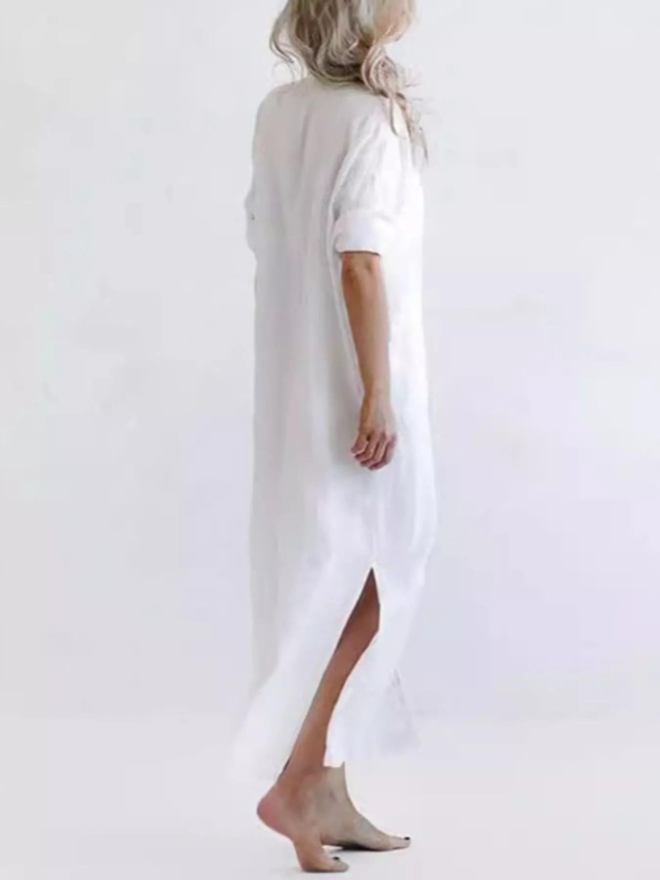 Plus-size green maxi shirt dress with collared neckline, button front, rolled sleeves, pockets, and side slit