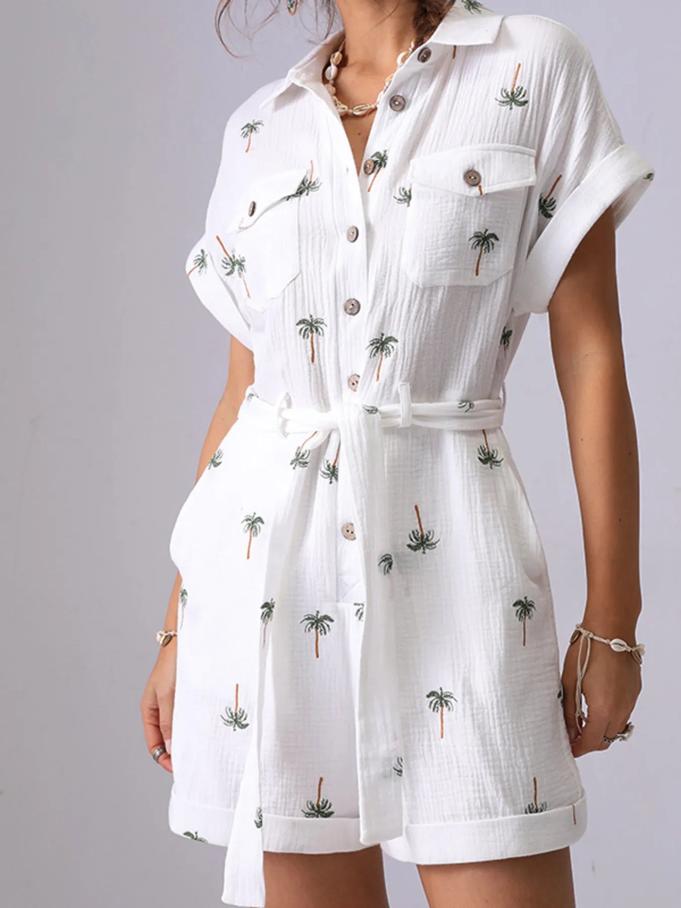 Palm Tree Print Short Sleeve Button-Up Romper with Belt and Pockets.