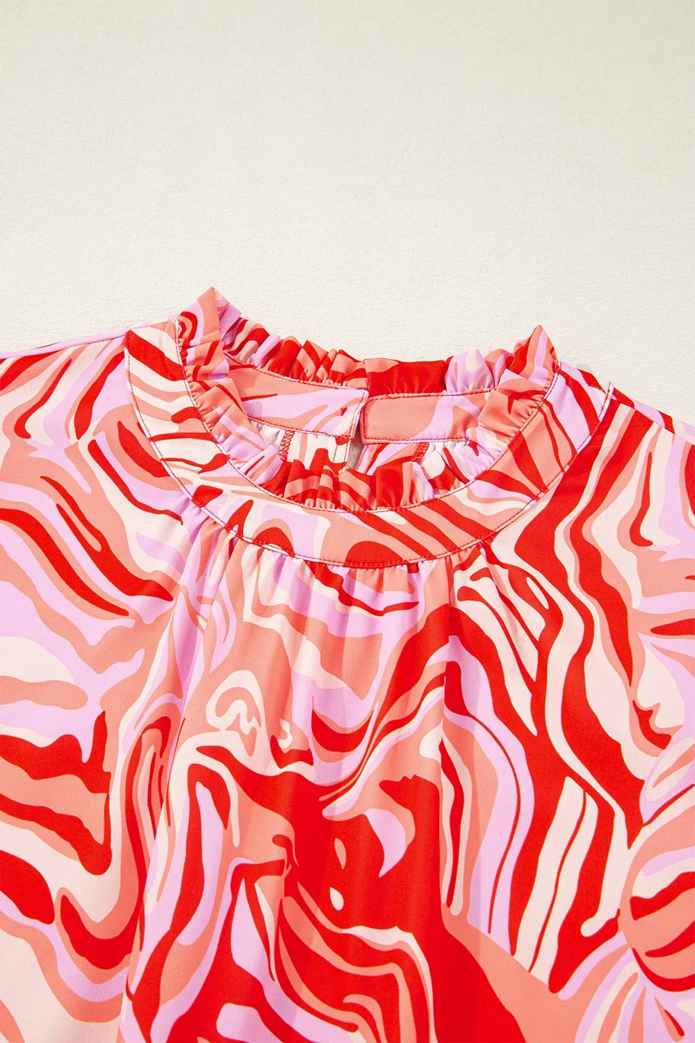 Abstract Print Ruffled Short Sleeve Mock Neck Blouse.