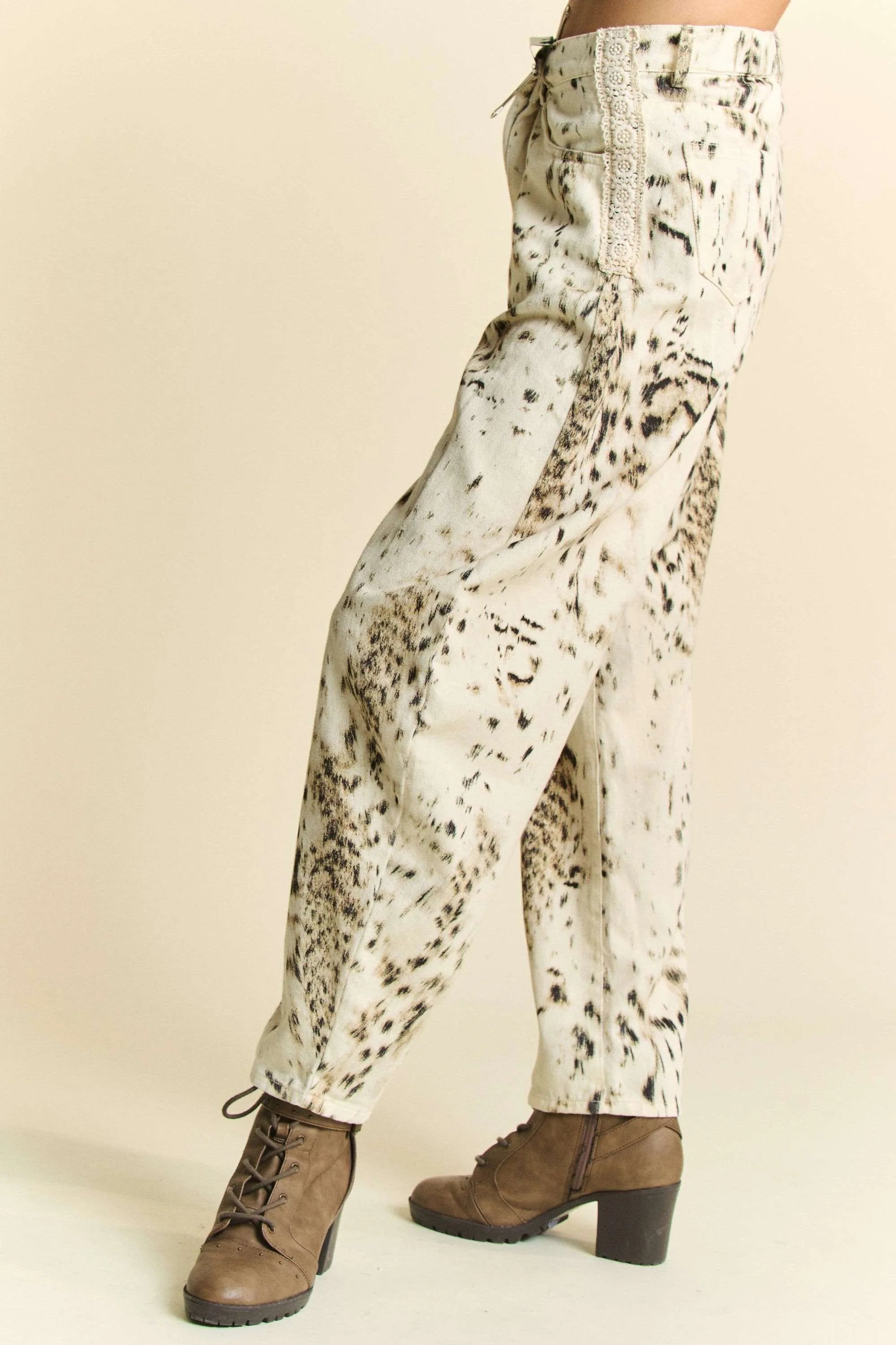 Abstract tie-dye dot lace detail barrel pants with pockets on a cream background.