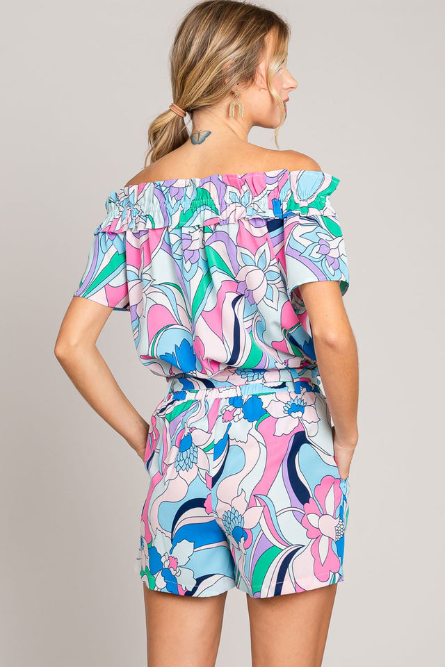 Abstract print tie-front shorts with pockets and ruched detail.