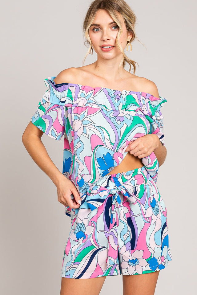 Abstract print tie-front shorts with pockets and ruched detail.