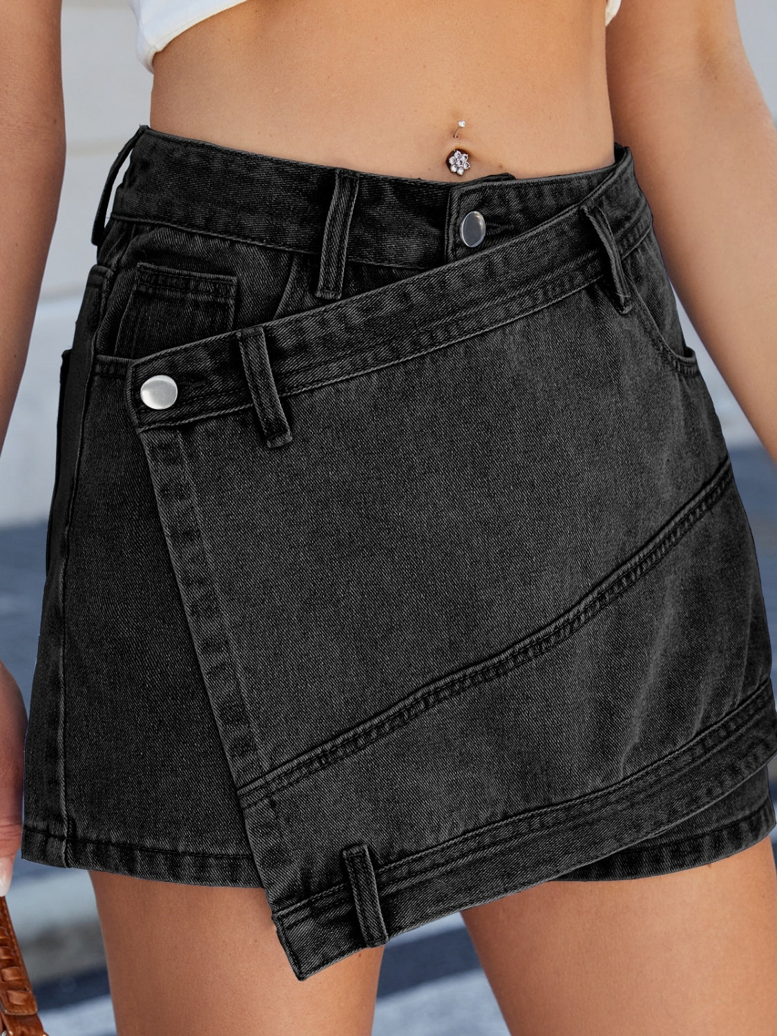 Asymmetrical denim skort with pockets.