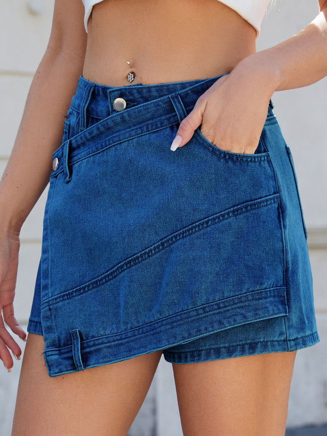 Asymmetrical denim skort with pockets.