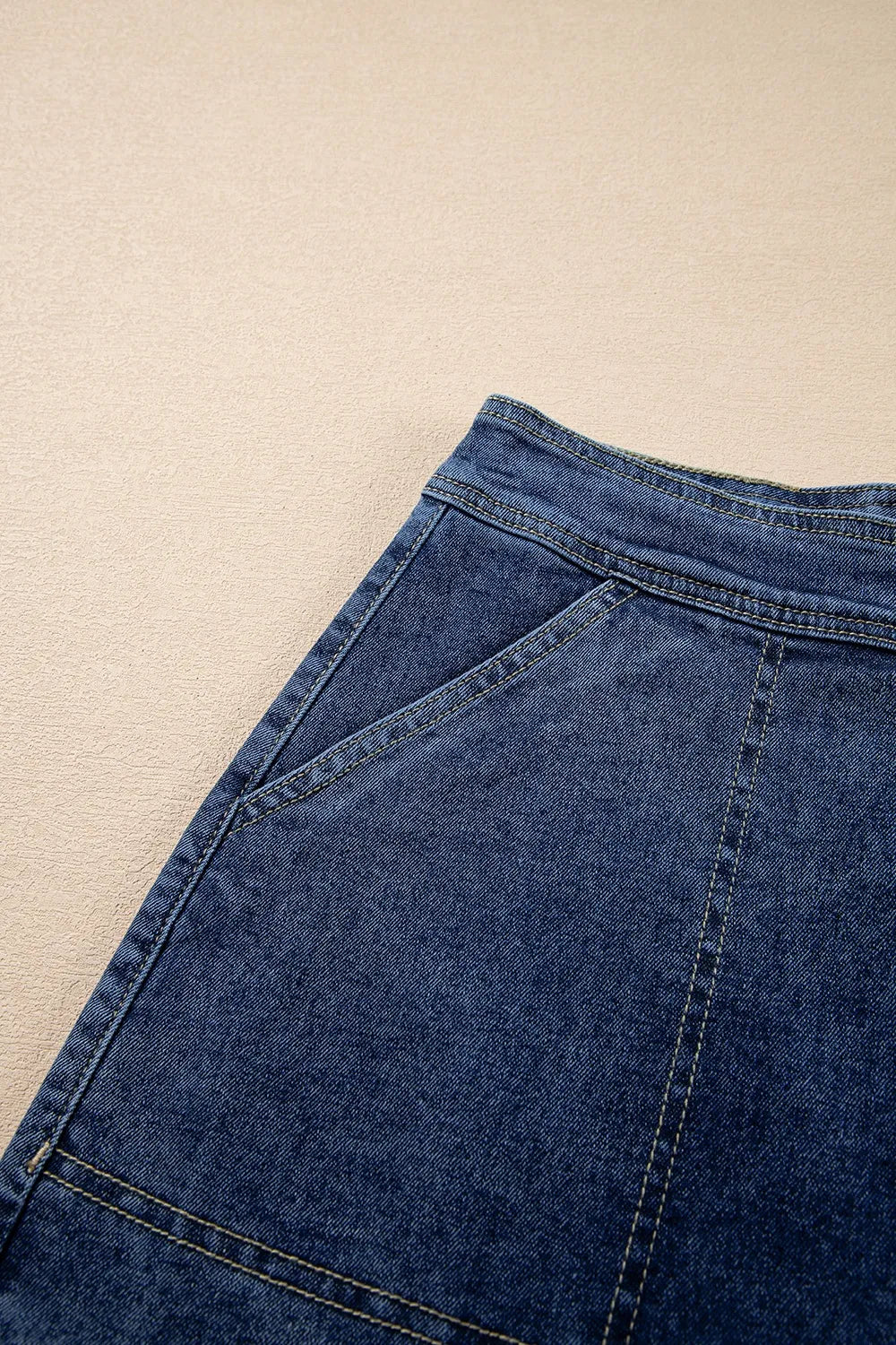 Asymmetrical denim skort with pockets.