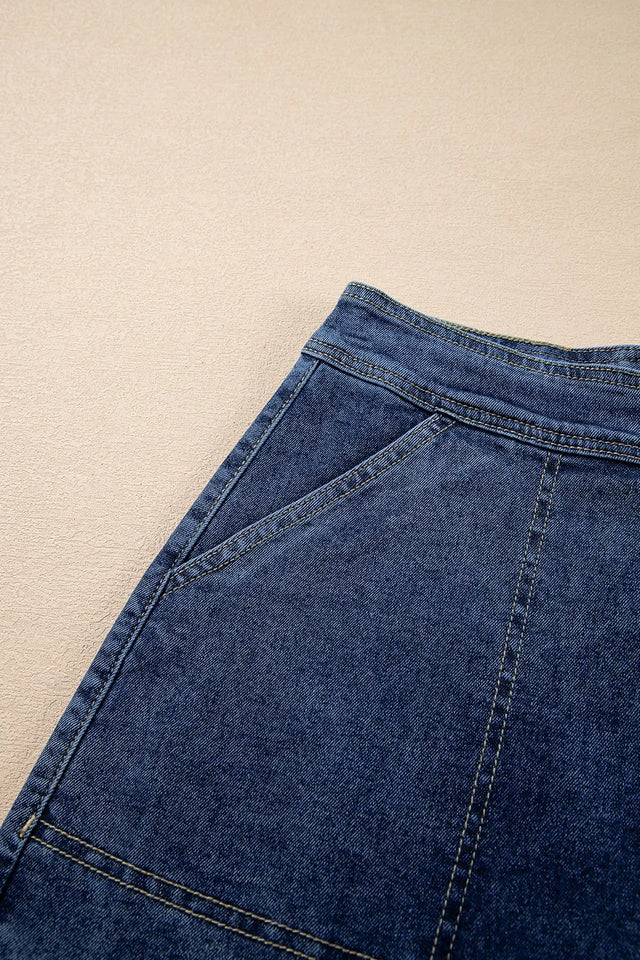 Asymmetrical denim skort with pockets.