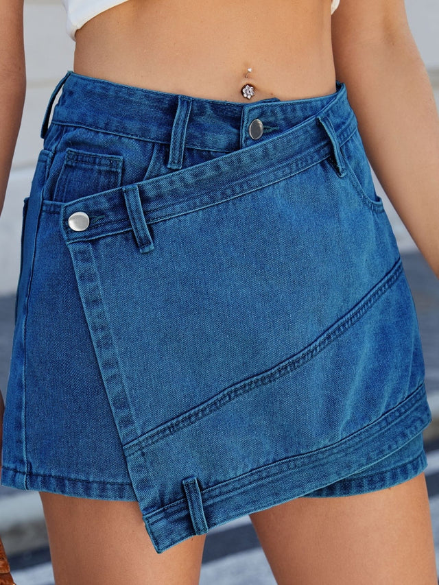 Asymmetrical denim skort with pockets.