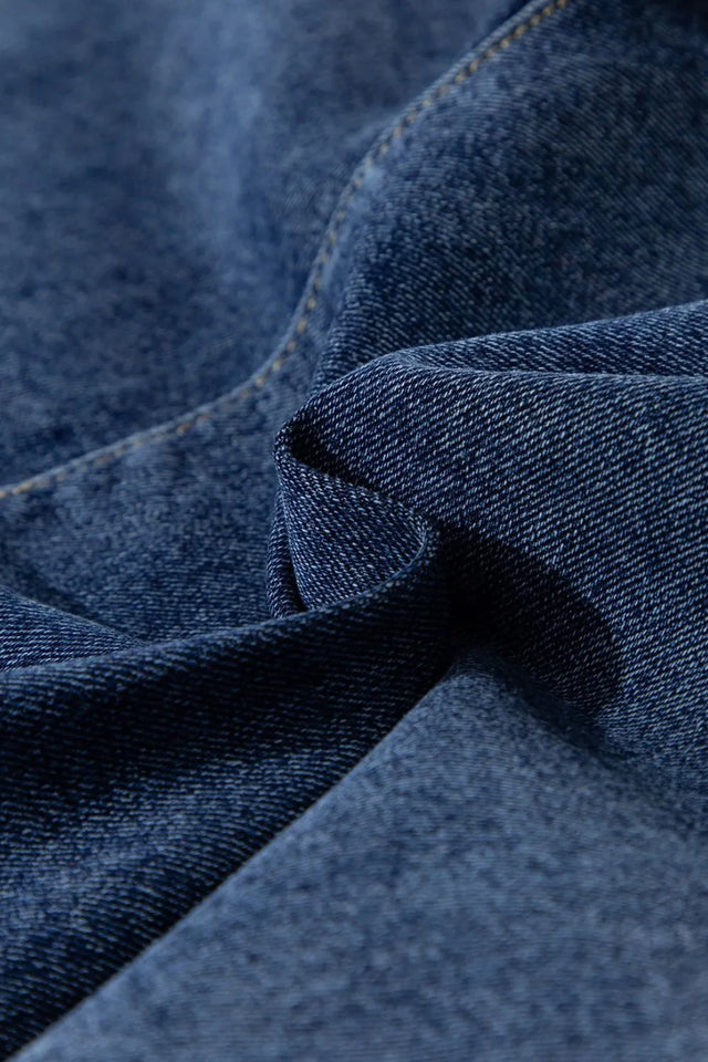 Asymmetrical denim skort with pockets.